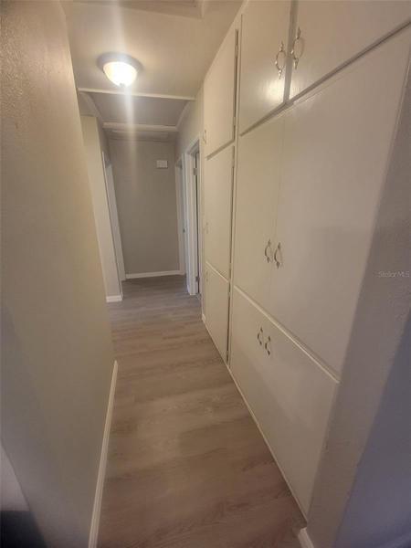 Hallway to the right of Living Room to Bedrooms & Bathroom. Extra storage spaceon right wall.