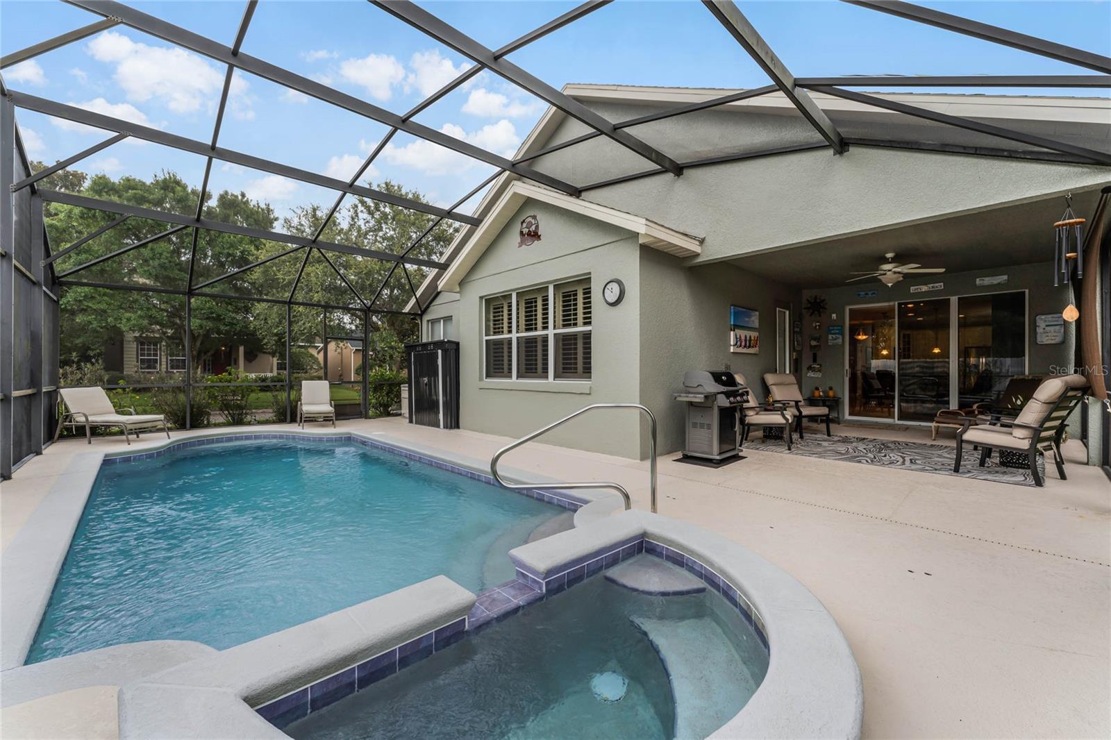 The screened enclosed heated pool and spa are perfect for year-round enjoyment and relaxation.