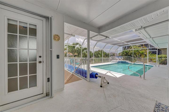 Pool bathroom entry. Stairway leading to Dock, Boat lift and storage room as well as the outdoor shower