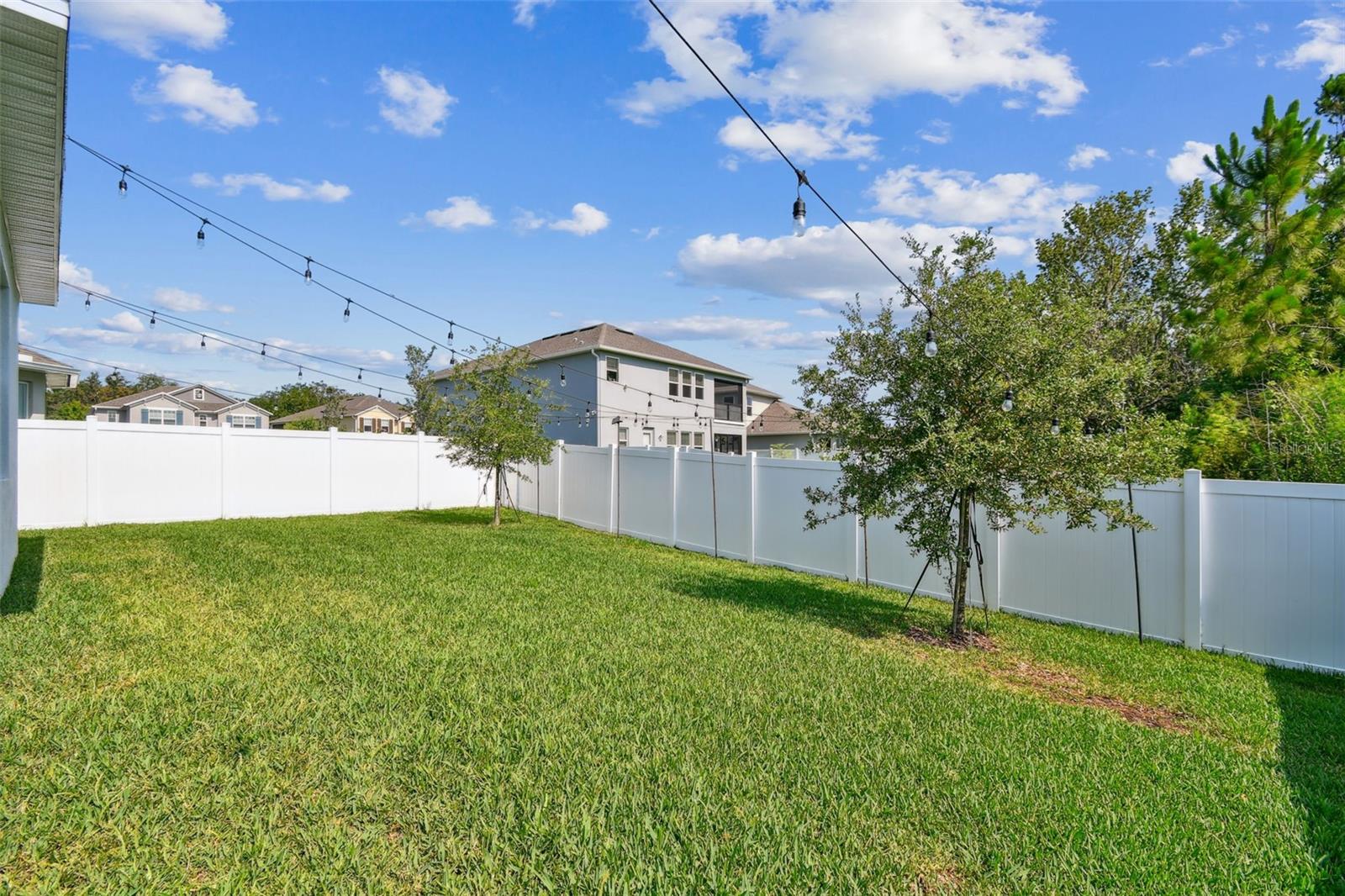 spacious backyard with new vinyl fence