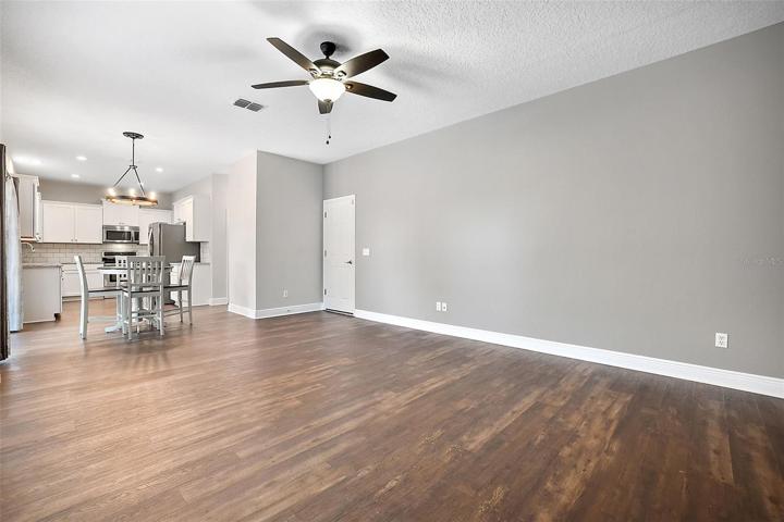 View from family room to breakfast nook and kitchen, door to attached garage ~