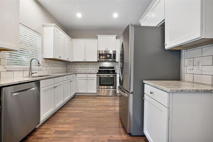 The updated kitchen overlooks the pool and backyard ~