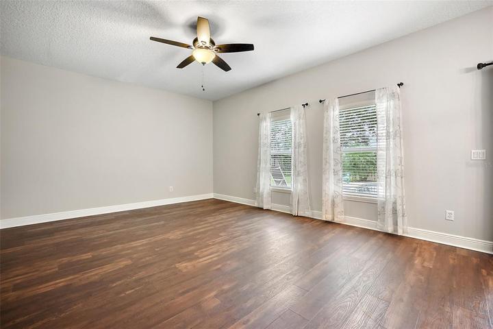 Family room windows offer views of the backyard and pool ~