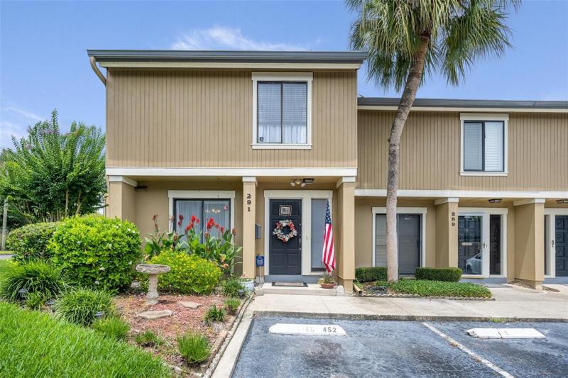 Exterior Front with Reserved Parking Space in Front of Unit - Corner Unit