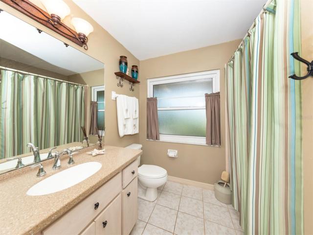 Bathroom 2 has linen closet, solid countertop, tub and shower combination