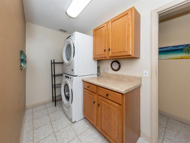 Separate laundry room with storage and area to fold clothes
