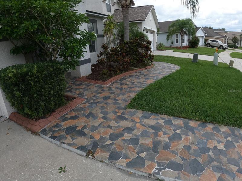 Front of home with tiled walkway