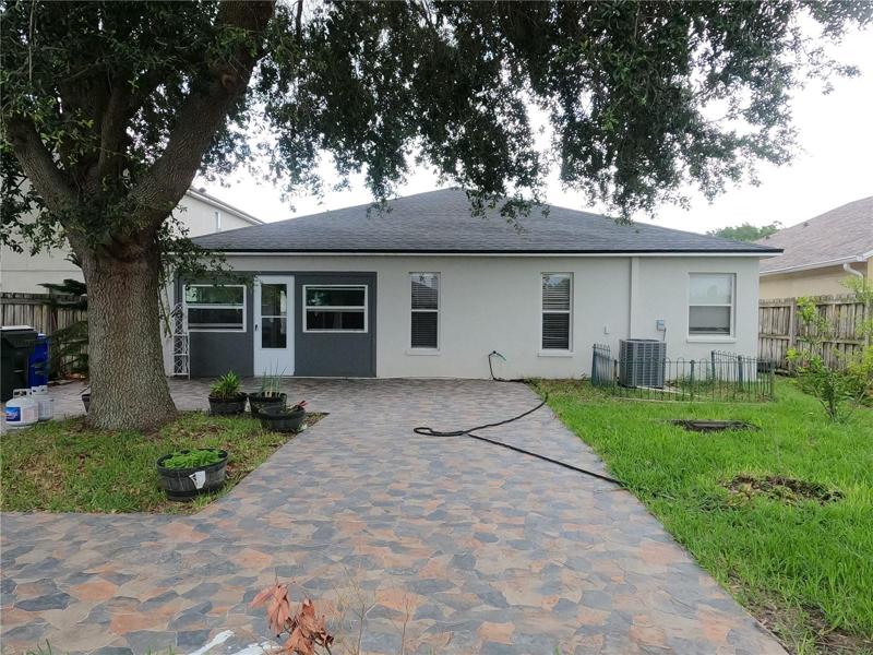 Rear of home with tile