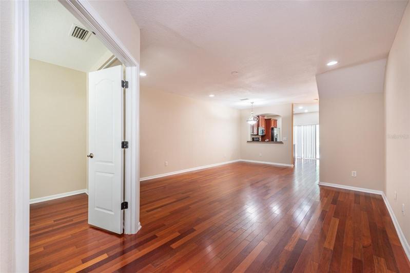 The office/den is on the left when you come in with double French doors. Great room plan with living/dining area and the kitchen with pass thru window and breakfast bar beyond.