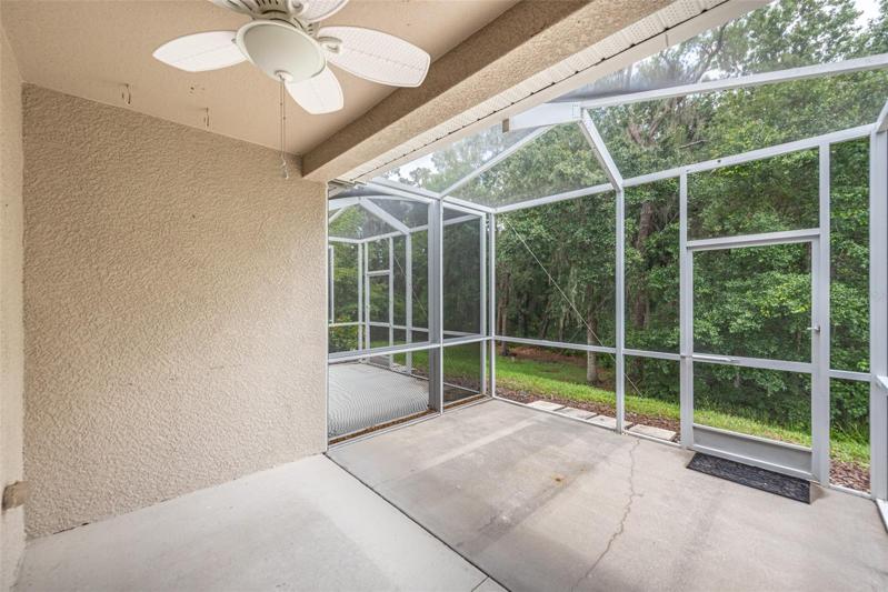The screened porch has a ceiling fan and there is a locked closet for extra storage. Notice there is conservation area behind, so no backyard neighbors.