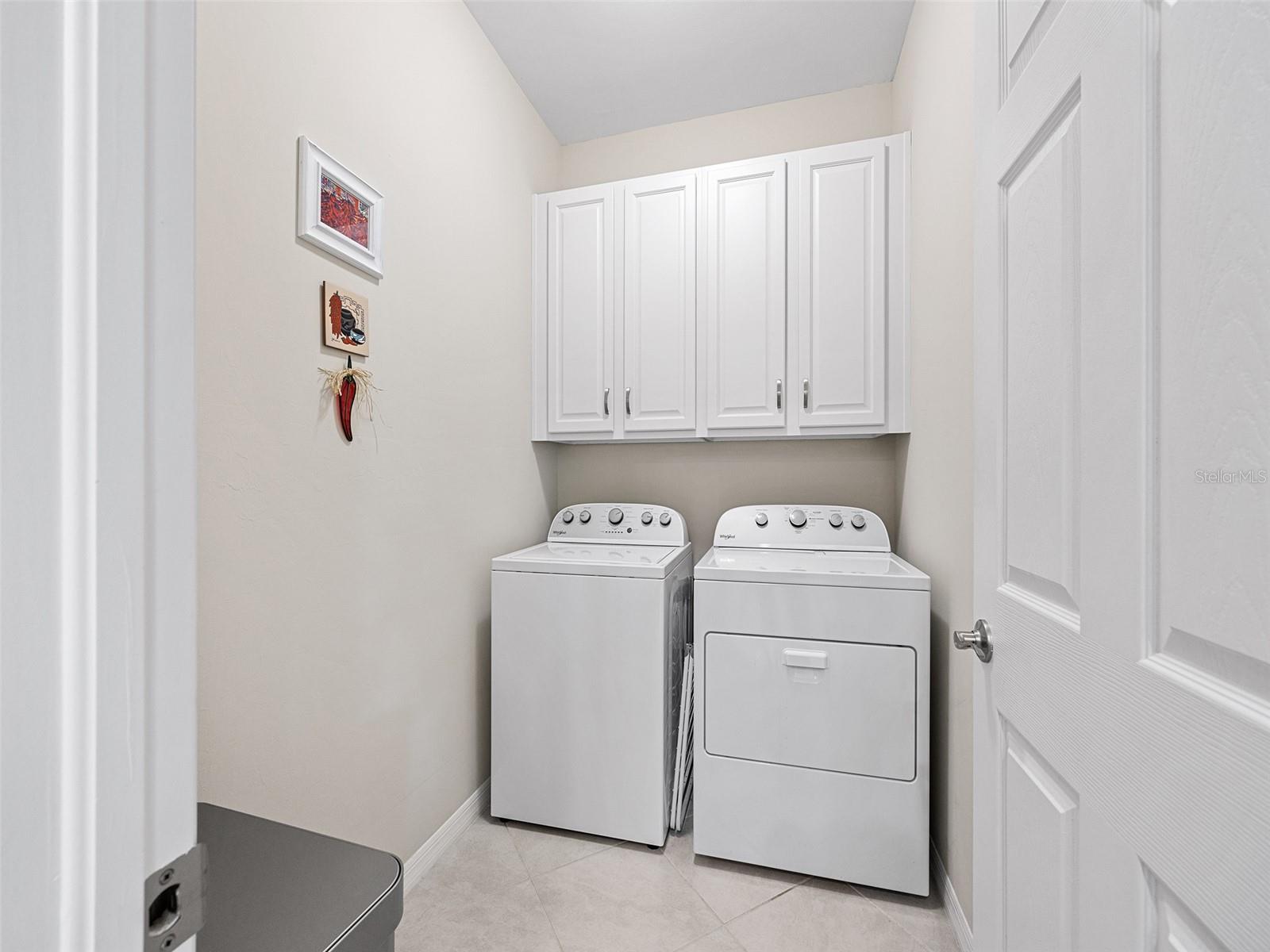 The laundry room is located off of the kitchen