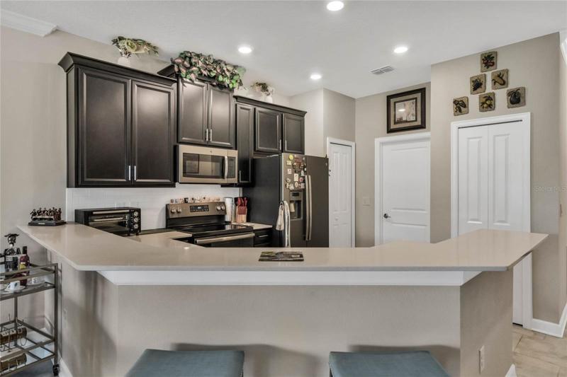 42" Espresso-Stained Cabinetry adorned with Crown Molding