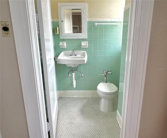 half bath located off room 4 upstairs of main bldg