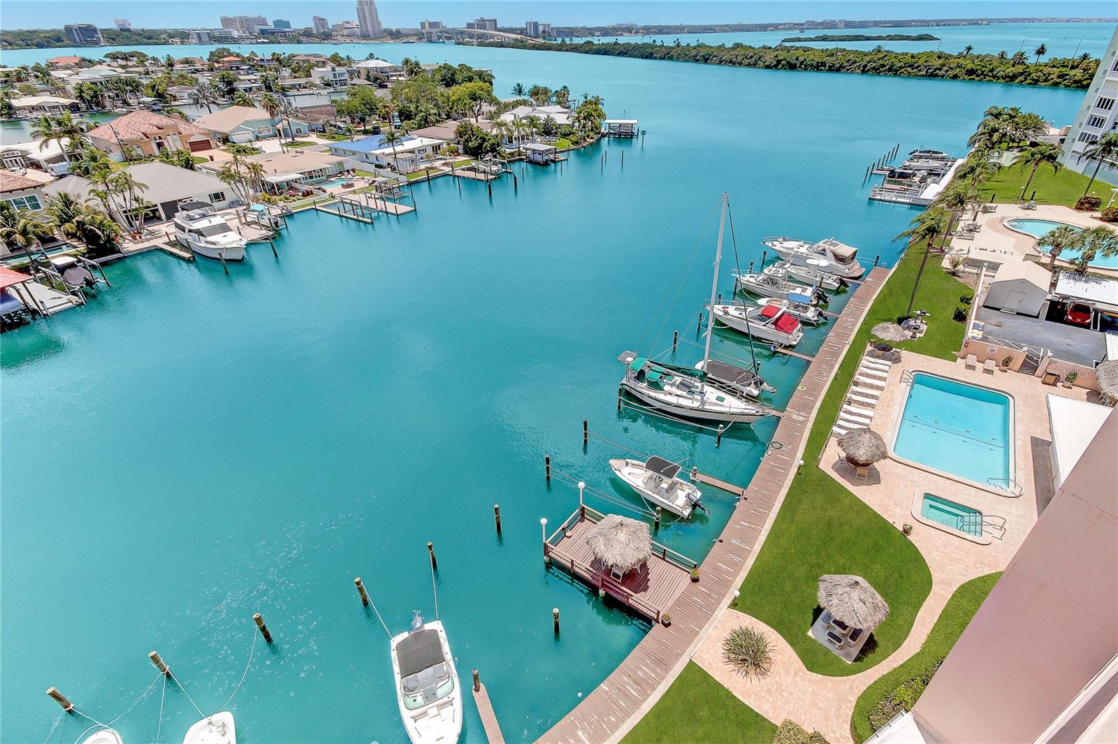Resort style building with heated pool, spa, restrooms, sauna, kayak storage, tennis, shuffleboard, marina and tiki bar.