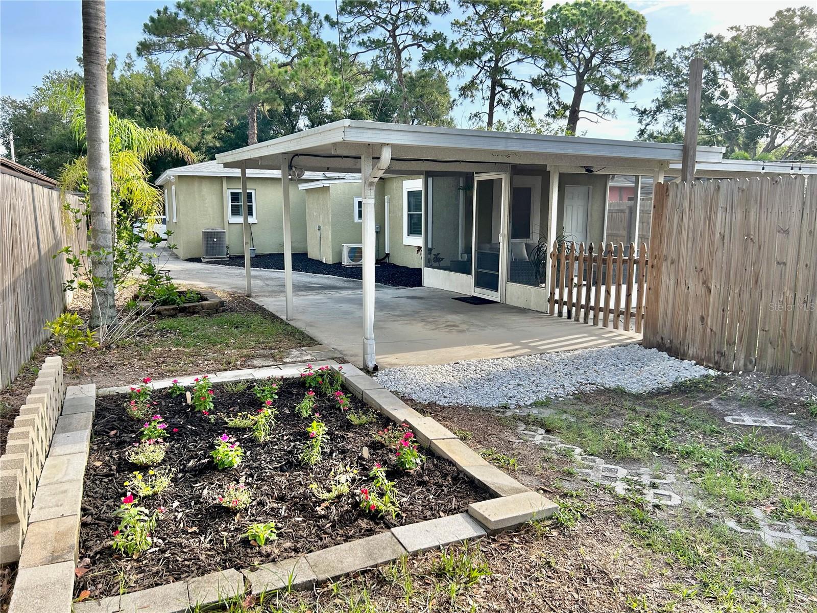Looking at the rear of the home &amp; gardens waiting for you to enjoy, taken from alley