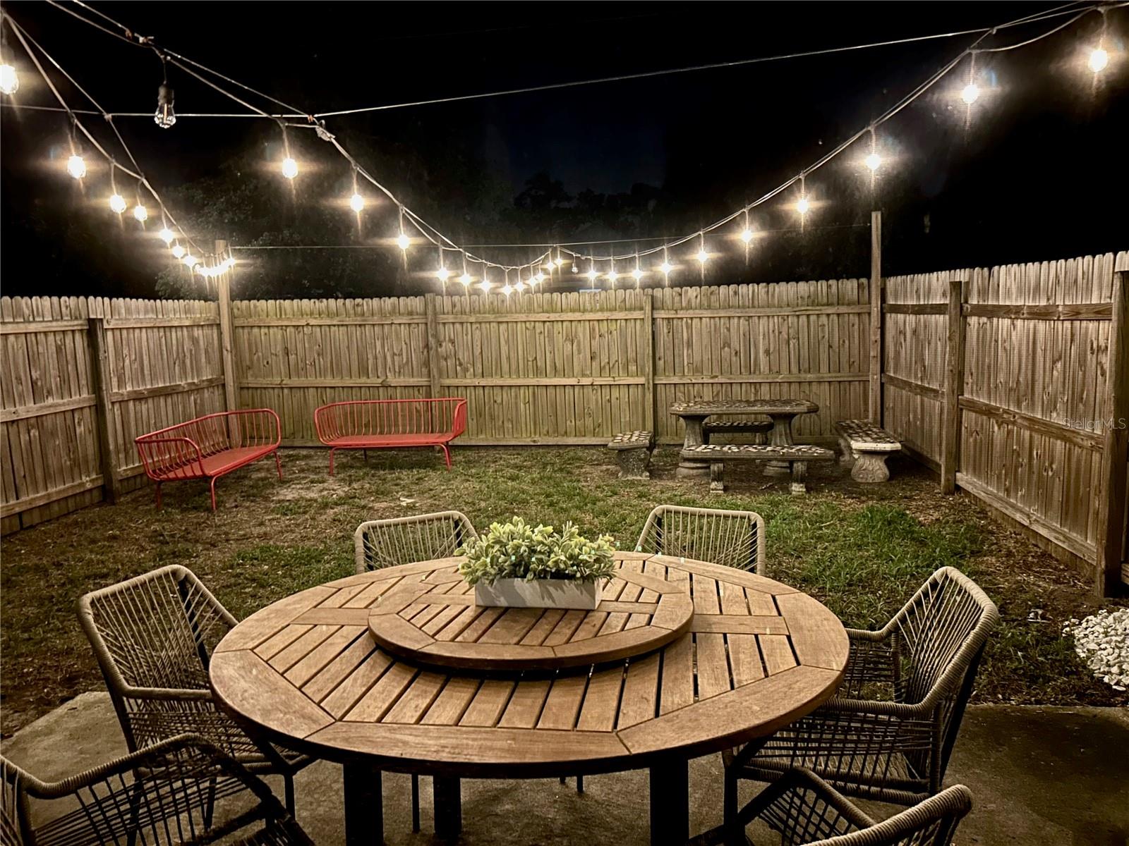 Backyard under the glow of cafe lights.