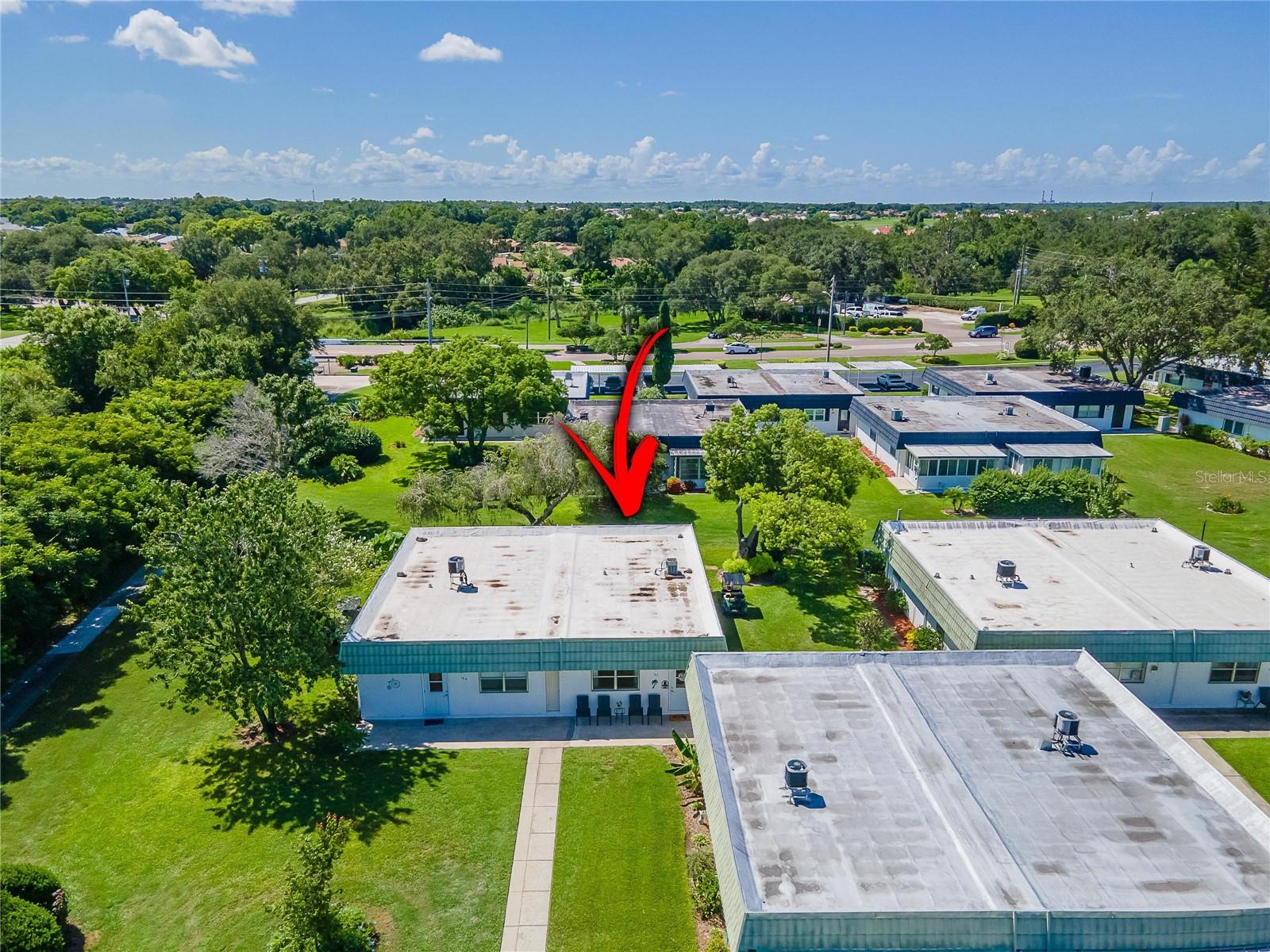 The condo backs up to a private wooded area with a golf cart trail to the north clubhouse