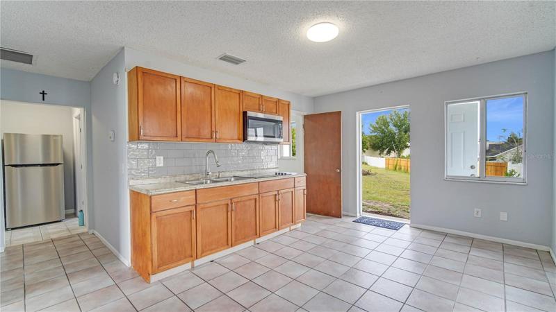 Entrance showing kitchen/family room w/ lots of natural lighting