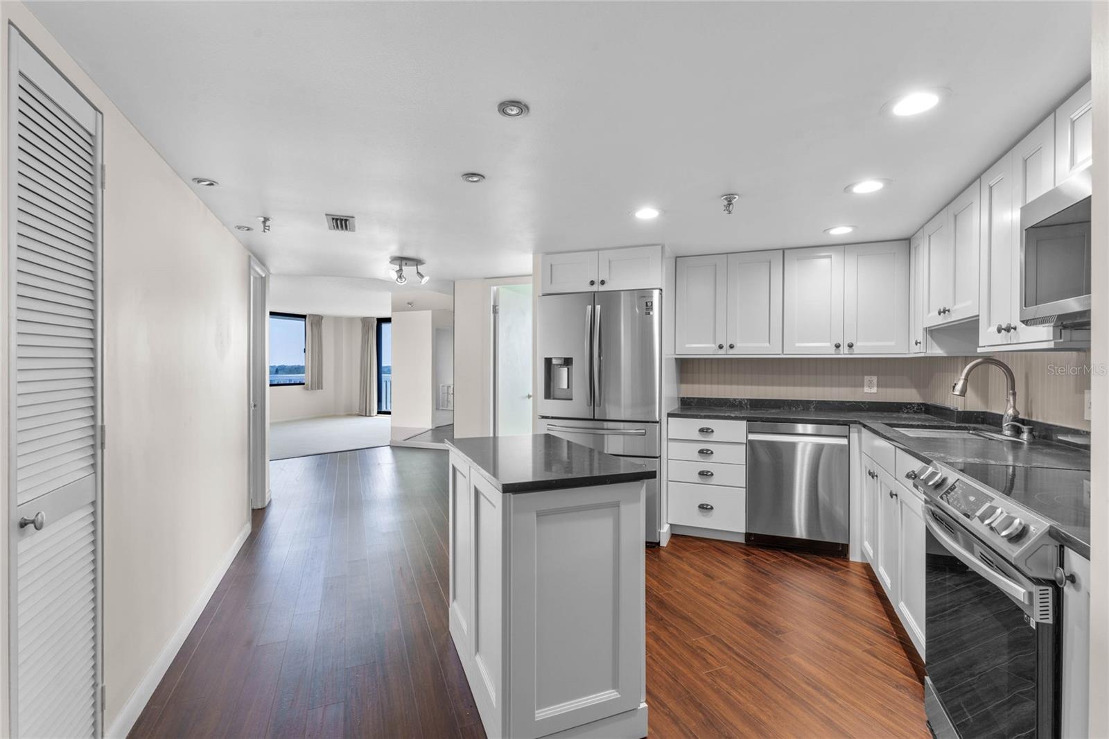 Kitchen with view into dining and living room