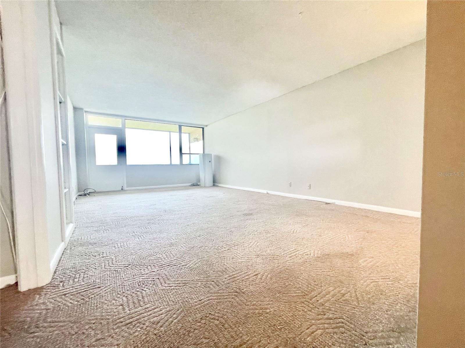 Living area looking toward sun-porch (plastic on windows for painting of exterior)