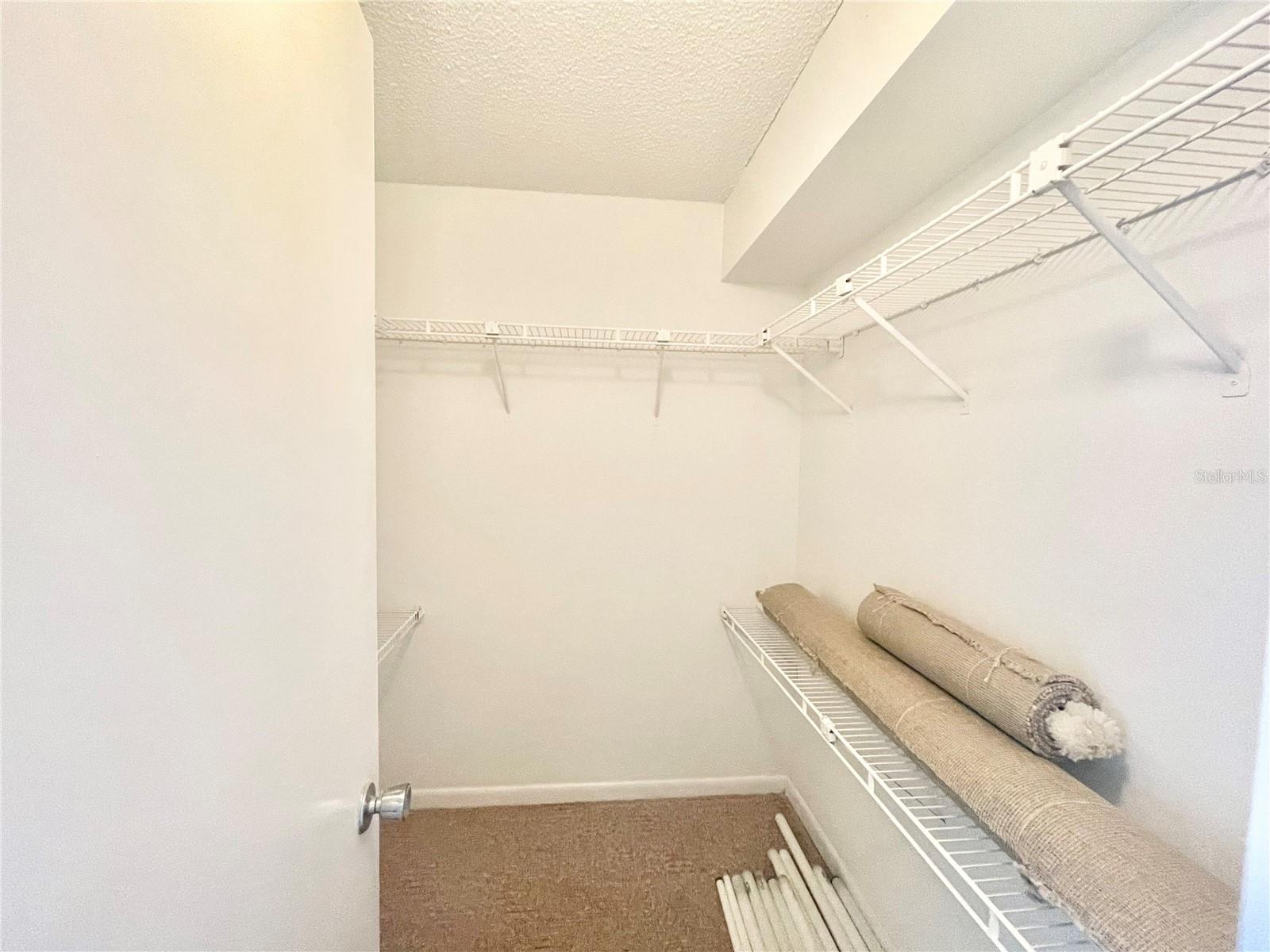 Walk in closet in primary bedroom