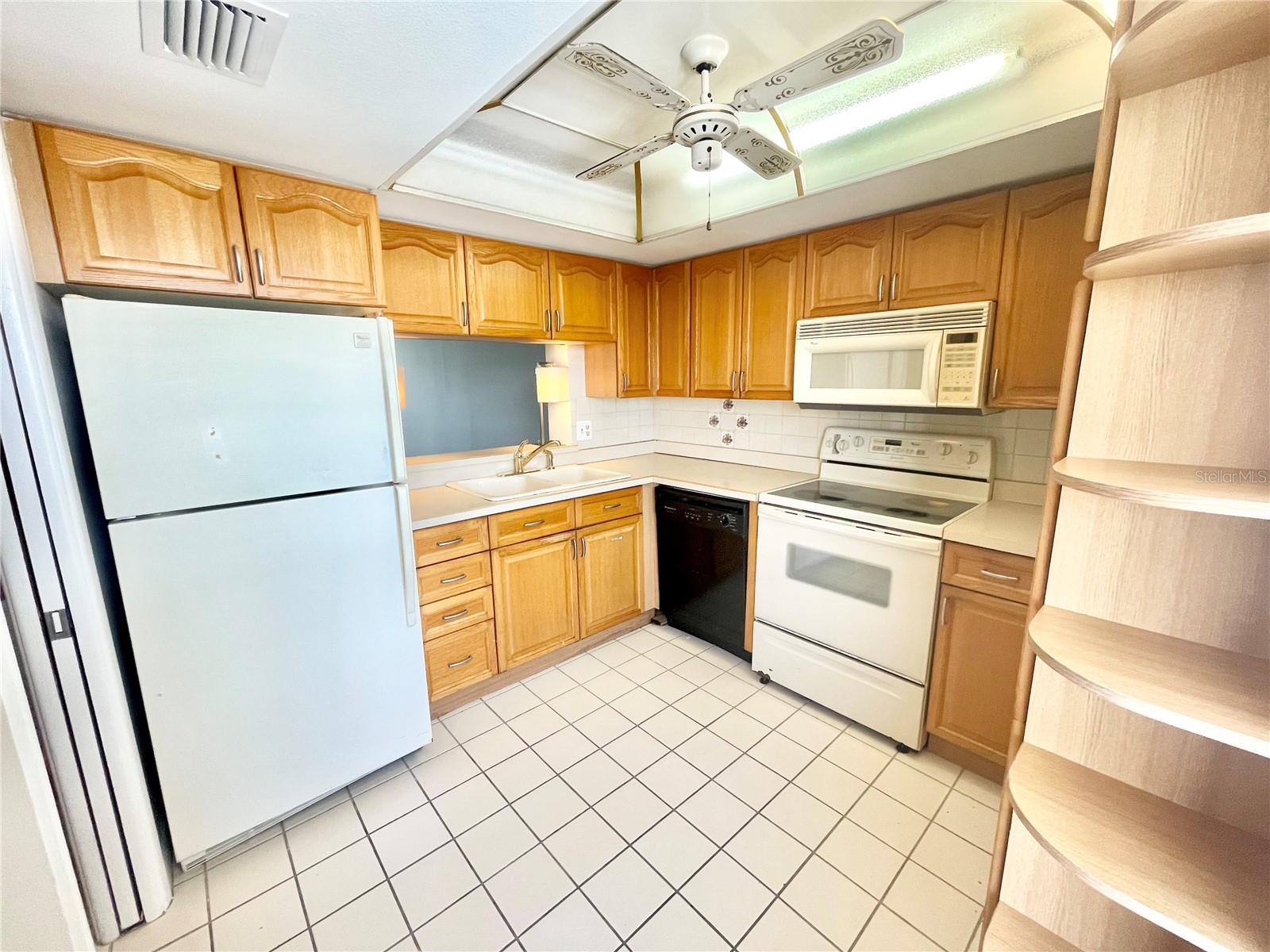 Kitchen with wood cabinetry and a bright sunny window