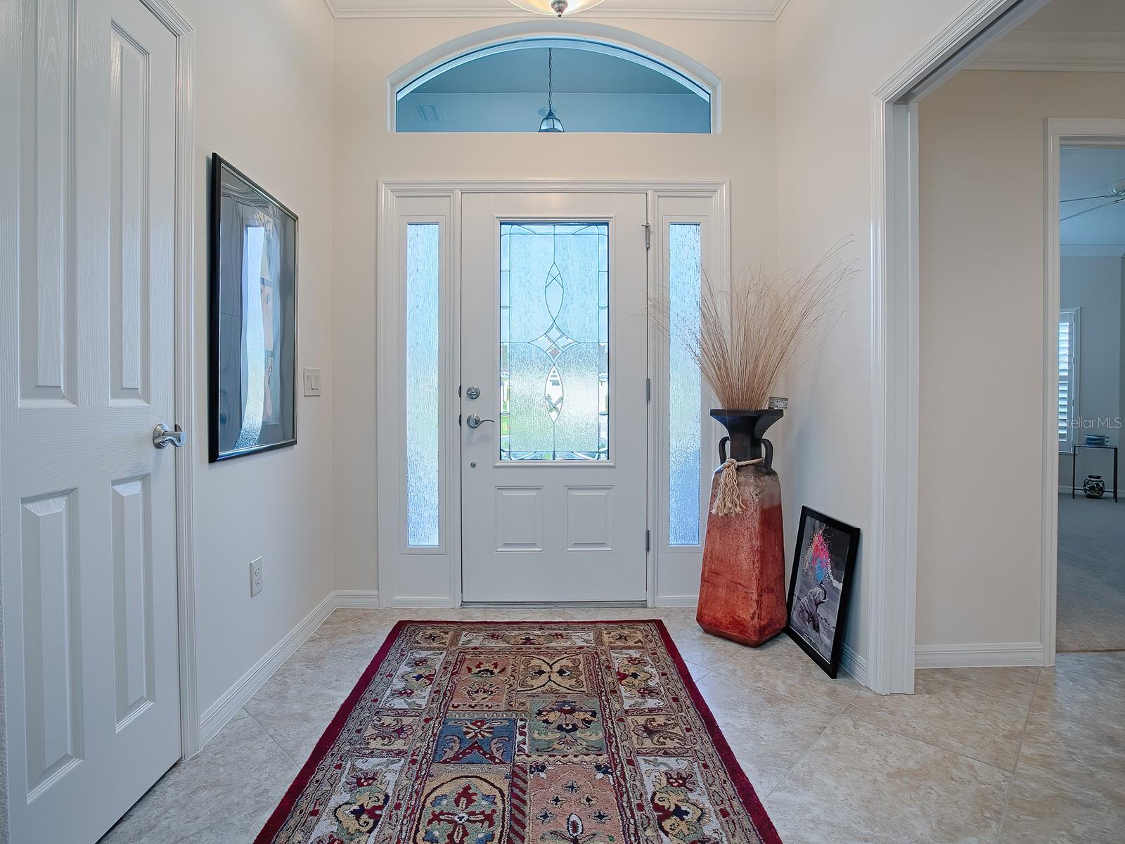 GORGEOUS LEADED-GLASS DOOR AND TILED FLOORING IN THE FOYER