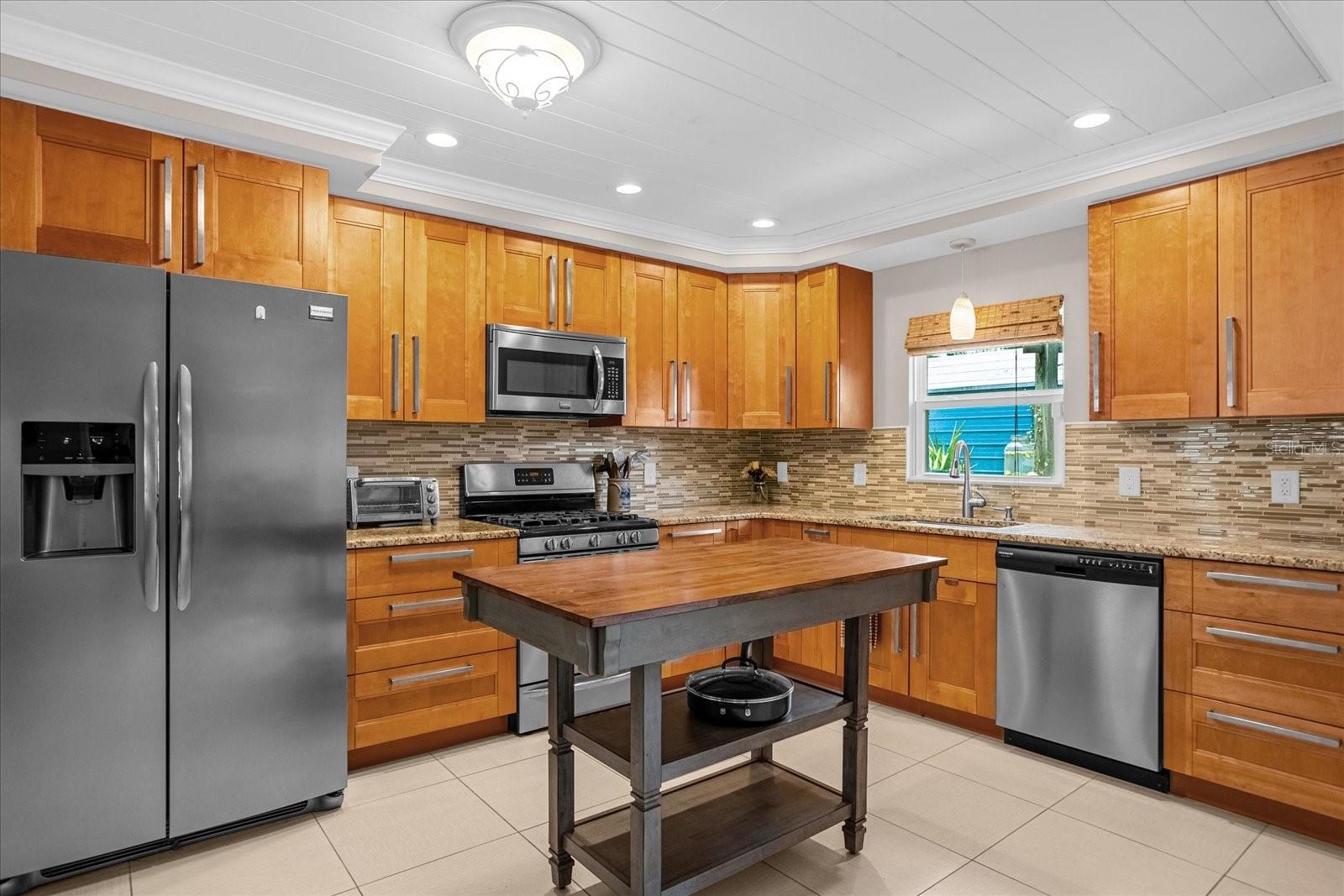 IMPECCABLE RENOVATION in this kitchen giving you a GAS stainless steel stove, a stainless steel refrigerator, dishwasher &amp; microwave as well.  Plus a perfect custom wooden movable kitchen island.
