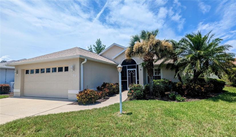 Front of home with lush plantings and screened entrance