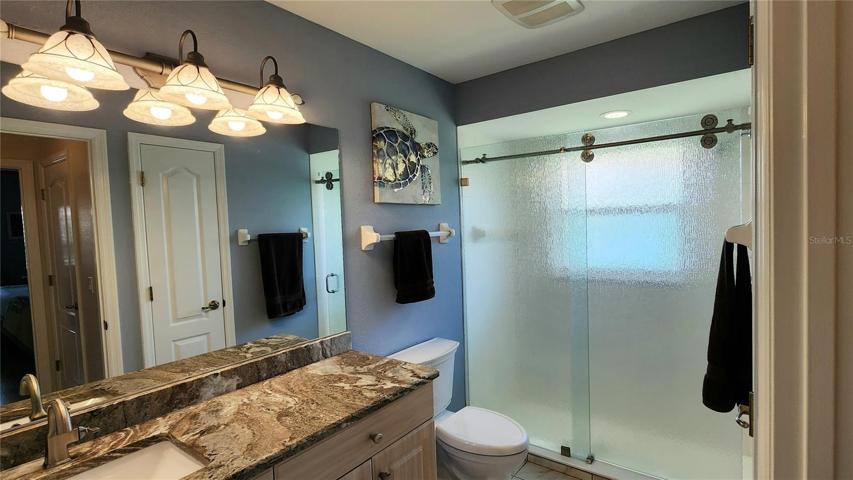 Updated guest bath with glass barn door shower