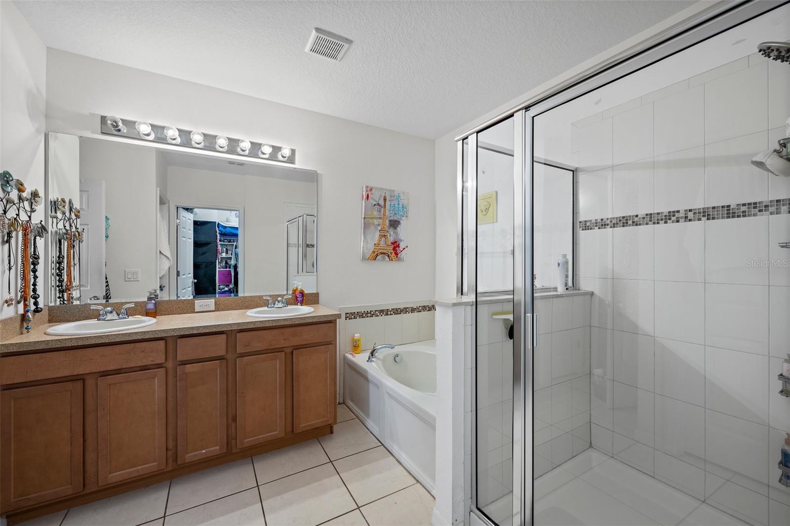 This master bathroom offers plenty of space with a roomy walk in closet