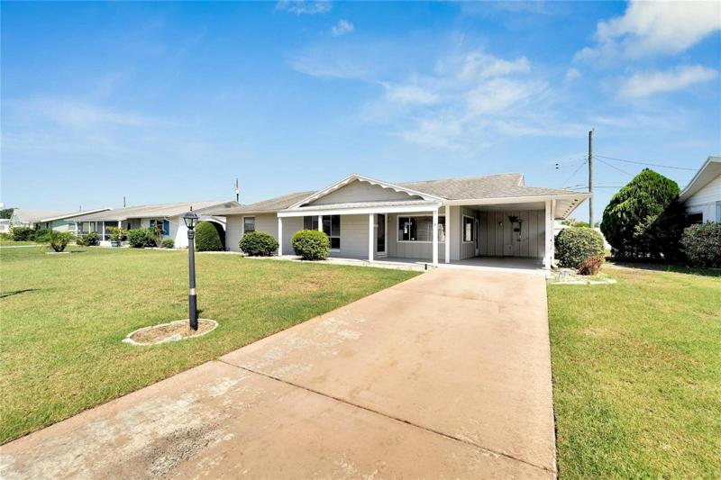 Large front yard and a driveway for multiple cars.