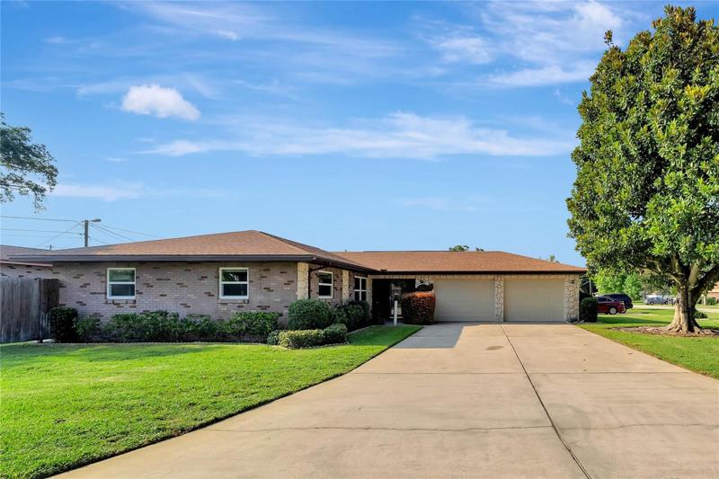 Exterior front oversized driveway. Corner lot