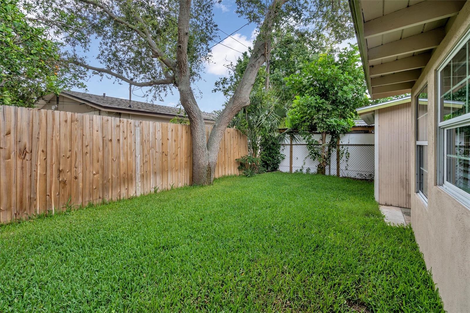 Lush backyard complete with irrigation and new fencing