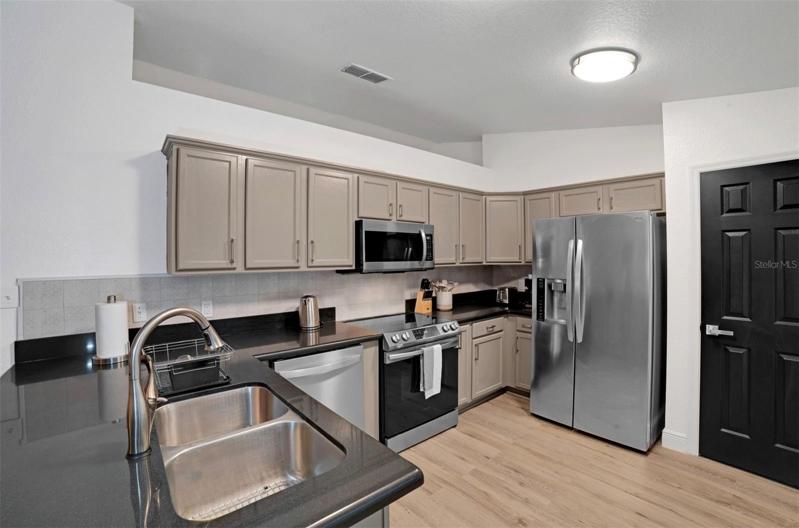 kitchen with granite and newer SS appliances