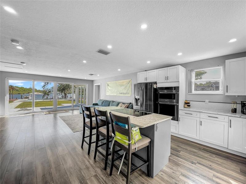 New Kitchen open to Living Room, new LG Black Stainless Appliances, granite countertops.