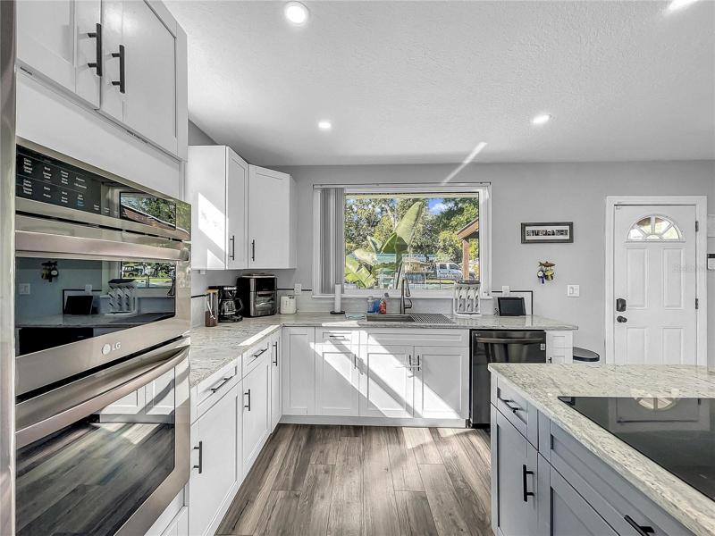 New Kitchen open to Living Room, new LG Black Stainless Appliances, granite countertops.