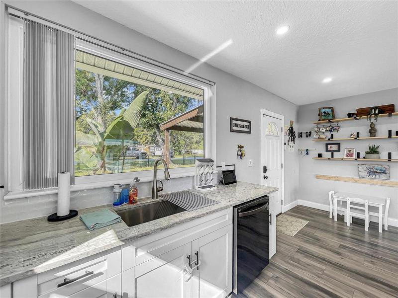 New Kitchen open to Living Room, new LG Black Stainless Appliances, granite countertops.