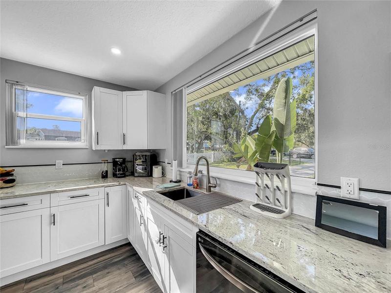 New Kitchen open to Living Room, new LG Black Stainless Appliances, granite countertops.