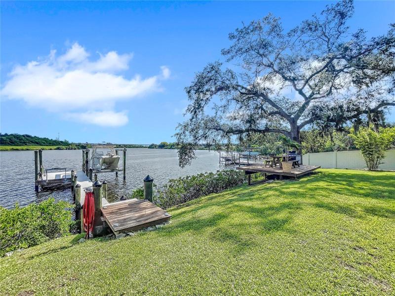 New composite decked dock and 14,000lb boat lift, Killer Dock fish cleaning table, water and electric.