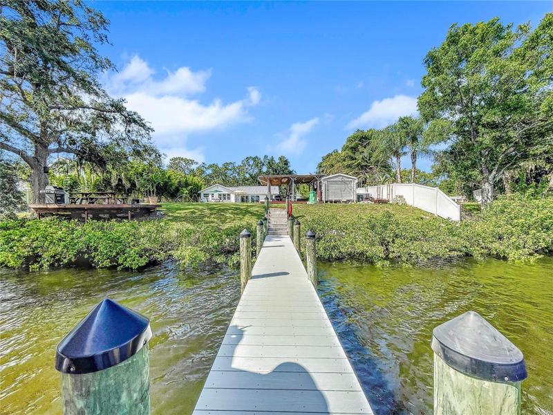 New composite decked dock and 14,000lb boat lift, Killer Dock fish cleaning table, water and electric.
