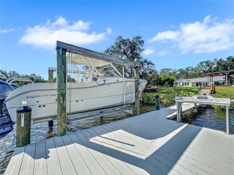 New composite decked dock and 14,000lb boat lift, Killer Dock fish cleaning table, water and electric.