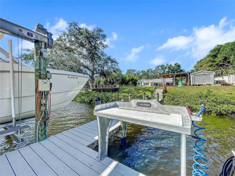 New composite decked dock and 14,000lb boat lift, Killer Dock fish cleaning table, water and electric.