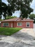 Front Elevation. There is a parking pad for 4 cars. The Gate opens to the separate entrance to the Mother In Law Suite or Next Generational Area - a separate 1 bedroom/1bath with Kitchenette and Living Room.