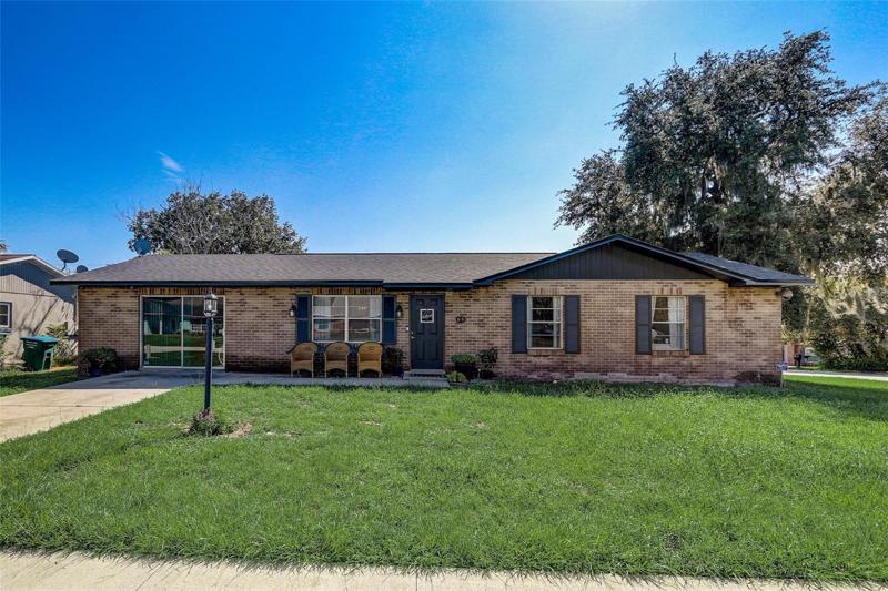 Deltona Lakes brick front charmer on a spacious CORNER LOT with a BRAND NEW ROOF and WATER HEATER (2023) and A/C (2022)!