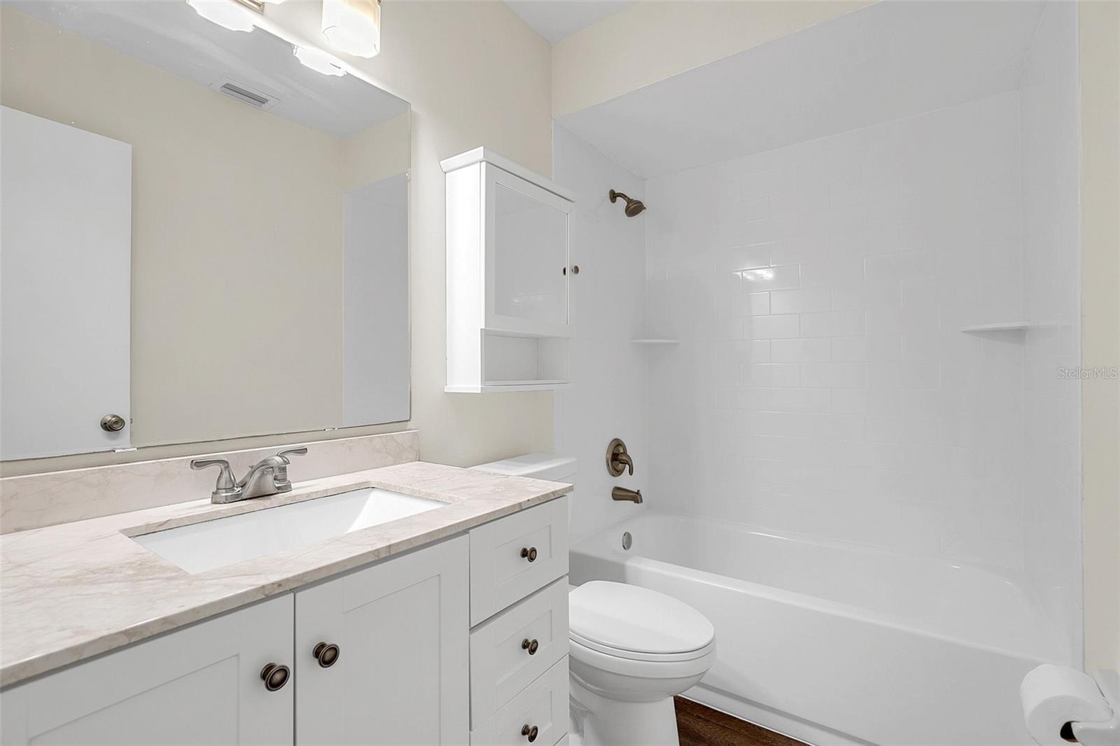 Newly renovated 2nd bath with new tub and shower surround with new fixtures, oversized vanity with newer with newer lighting