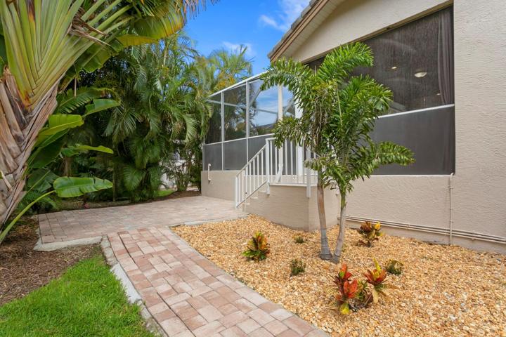 The 2nd outdoor pavered patio space, surrounded by updated tropical landscaping