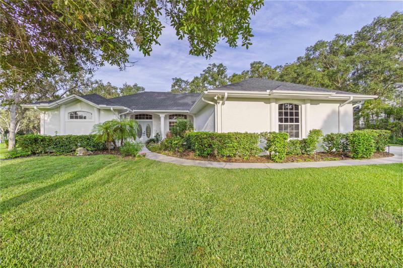 Lush green grass and landscaping greet you as you walk up to the front doors of this beautiful home