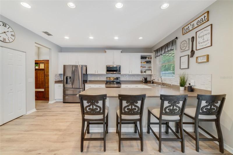 The updated kitchen offers the home chef a comfortable layout with plenty of storage, breakfast bar seating, stainless steel appliances, updated cabinets and backsplash (2020) and a lovely window over the sink!