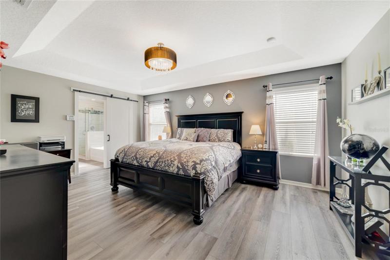 Your bedrooms are also on the second floor including a must see primary suite under a decorative tray ceiling, with a chic modern color palette, 13x11 WALK-IN CLOSET and another barn door at the entrance to your en-suite!